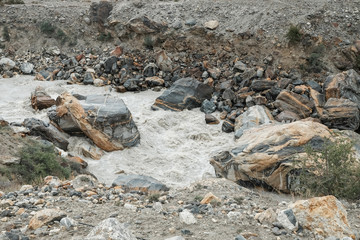 Current of river way with full of rocks