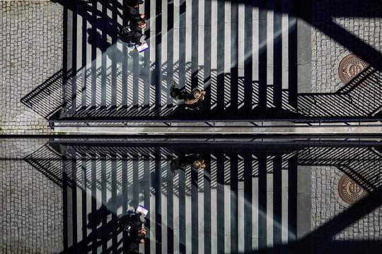 Stockholm, Sweden  Pedestrians on a staircase on Kvarnholmen are reflected in a glass wall.