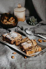 Butter-free, sugar-free banana bread with oat flour, soft curd cheese and honey. Top view of sliced banana bread on gray marble background. Ideas and recipes for healthy diet breakfast