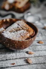 Butter-free, sugar-free banana bread with oat flour, soft curd cheese and honey. Top view of sliced banana bread on gray marble background. Ideas and recipes for healthy diet breakfast