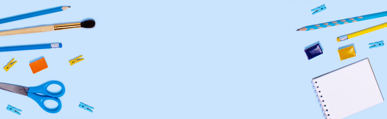 School supplies on blue background. Back to school flat lay picture.