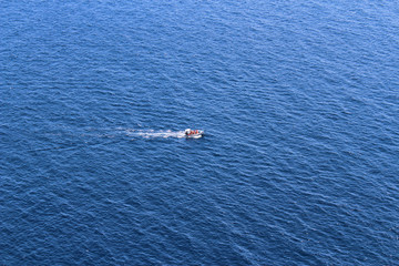 Boat crosses a blue sea