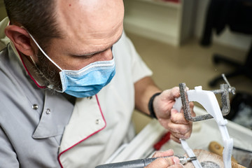 Technician developing a prototype face mask for corona virus protection. World emergency.