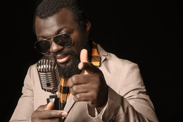 Male African-American singer on dark background