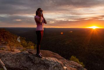 Athletic woman wearing a medical protection mask outdoors in nature sunset  COVID-19 pandemic concept