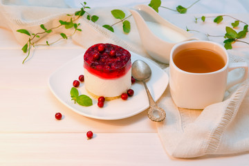 Cottage cheese, yogurt dessert with cranberry jelly, cranberries in a plate on a wooden table. the theme of healthy food, diet