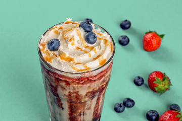 Berry milkshake in a glass transparent glass