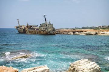 Paphos. Shipwreck. The ship crashed on the coastal rocks at the shore of Mediterranean sea. Tourist attractions of Cyprus.
