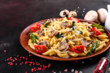 Pasta with mushrooms, cheese, spinach, rukkola and cherry tomatoes
