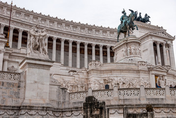Fototapeta na wymiar Rome Italy. View of the Vittoriano, also called the altar of the fatherland. Detail on sculpture the concord and on statue of King 