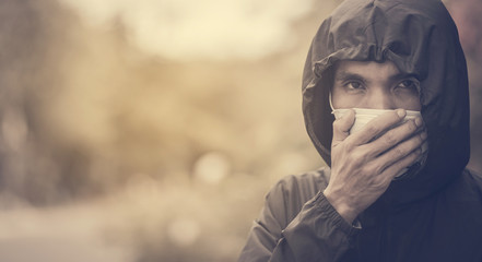 Man use surgical mask and black hood