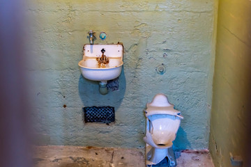 Broken rusty and dirty sink and toilet bowl from a cell at Alcatraz Prison San Francisco California...