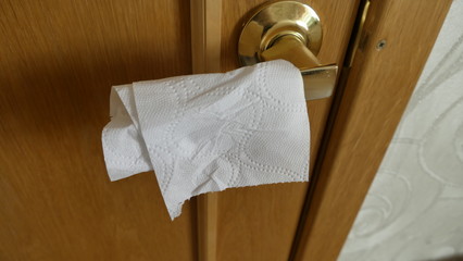door handle wrapped with toilet paper to protect against coronavirus