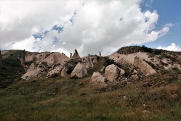 Amazing landscape of Cappadocia in the Valley of the imagination. Against the background of blue sky and clouds, strange rocks, like mushrooms.