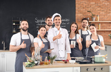 Male chef and group of young people during cooking classes