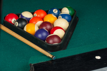Billiards balls and cue on billiards table. Billiard sport concept