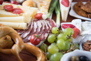 Traditional Serbian and Balkan food Dried meat fried meat 3 types of cheese Balkan cheese pie served with Serbian salad, bread, tomato, onions and olives Rustic Natural.Wooden background. Close-u