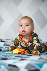 portrait of a little boy age 8 months and is smiling. Health and development of children