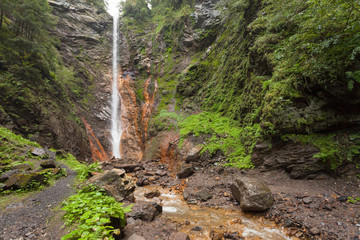small waterfall among the forest in val di Funes
