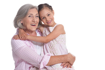 Grandmother hugging with her cute granddaughter isolated 