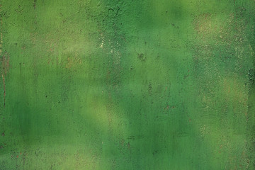 Green painted surface of a metal gate closeup. Texture with a gradient of green on the metal...