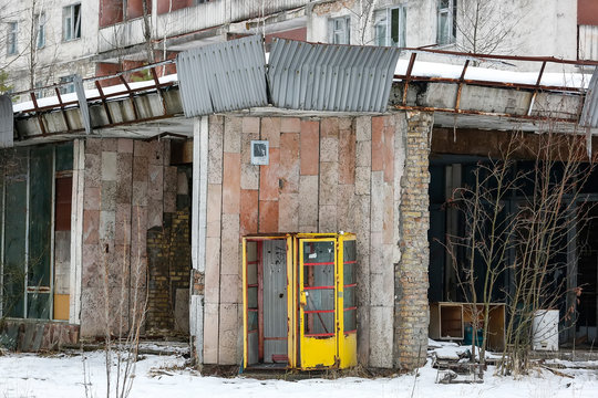 Old soviet yellow telephone booth in ghost town Prypiat. Pripyat, Chornobyl exclusion zone. December 2016