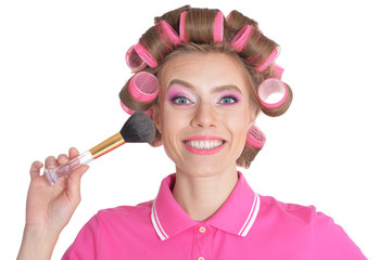 Portrait of beautiful woman with hair curlers isolated 