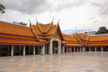 Fototapeta na wymiar Bangkok Wat Benchamabophit Temple interior with colorful roofs