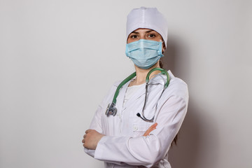 Doctor in mask and medical uniform with a stethoscope on his neck.