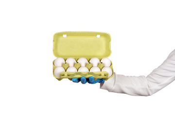 Female hand in disposable glove holds open box of eggs. Hygiene in the kitchen concept.