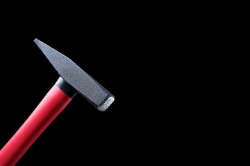 top of the nail hammer is tilted on a black background. high quality, beautiful color, high definition. space for text and ads. copy space for the label next to it