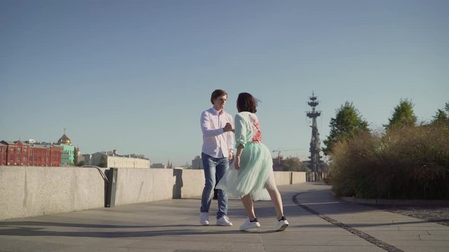 A couple dancing salsa on the street to live music. Dancers and musicians on the street.