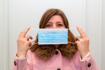 Close-up of woman wearing an anti-virus protection mask to prevent flu infection, allergies, virus protection, COVID-19, and corona virus pandemic disease 2019