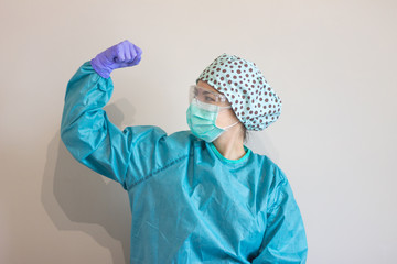 Photo of nurse making a sign of stay strong, to overcome the covid.