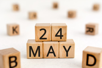 May 24 - from wooden blocks with letters, important date concept, white background random letters around