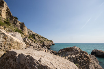 Travel in Crimea, Russia. Nature background. Colorful landscape with blue sea, mountains, rocks and sunlight in clear warm summer cloudless day. Concept of vacation on the coast