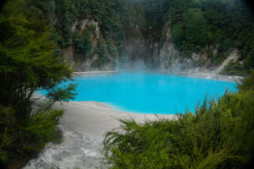 WAIMANGU VOLCANIC VALLEY, NEW ZEALAND - MARCH 03, 2020: Light blue geothermal lake in the Inferno crater
