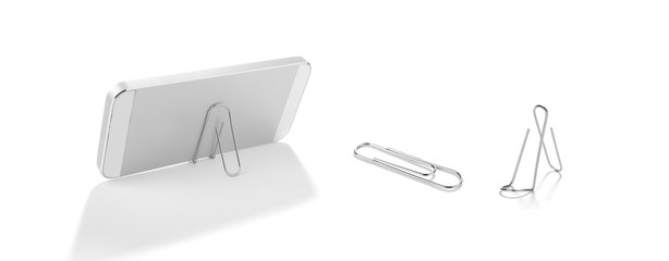 Lifehack; binder clip as a smart phone stand isolated on white background.    