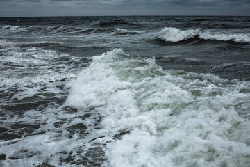 Dark clouds and the crash of sea waves during a storm in the Black Sea in Odessa.Art photo 
