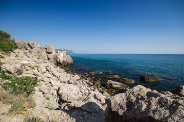 Travel in Crimea, Russia. Nature background. Colorful landscape with blue sea, mountains, rocks and sunlight in clear warm summer cloudless day. Concept of vacation on the coast