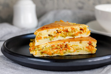 Pieces of pie with fresh young cabbage and carrots