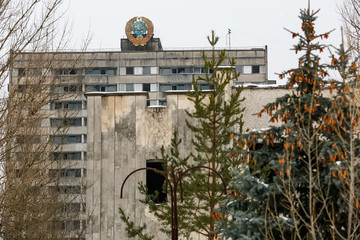 Soviet coat of arms on building in abandoned city of Prypiat, near Chornobyl nuclear power plant,...