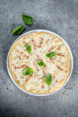 Pizza with cheese decorated with greens. Close-up shot