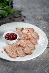 Boiled pork with sauce on a white glass plate