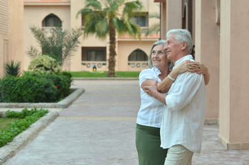 Happy senior couple at hotel resort posing