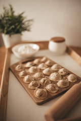 Obraz na płótnie Canvas Raw dumpling with meat. Preparation dumplings on a wooden board.