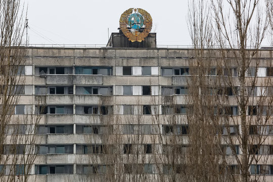 Soviet coat of arms on building in abandoned city of Prypiat, near Chornobyl nuclear power plant, Ukraine. December 2016