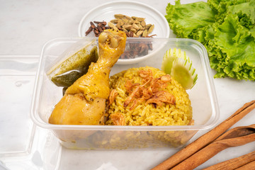 Chicken Biryani Yellow curried rice Thai style, Delicious spicy chicken biryani on rustic wooden background, 