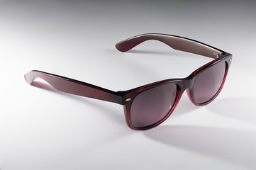 Red-brown sunglasses isolated on a white background, classic model, ray ban wayfarer