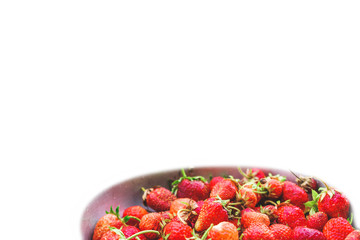 Ripe strawberries with a summer house in a plate on a white background. Healthy food. Place for text.